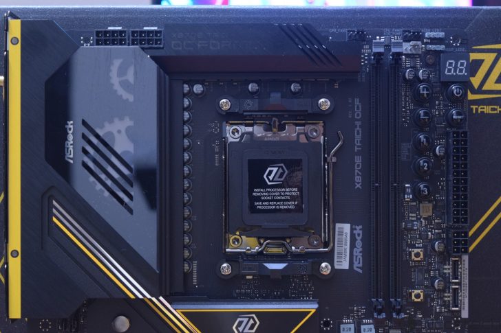 ASRock X670E Taichi OCF motherboard with visible CPU socket text “AMD REMOVE” and warning message.