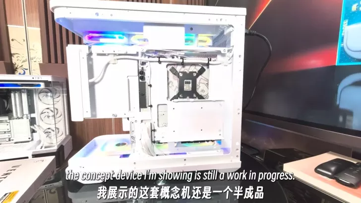 A white open-frame PC case with cooling fans, RGB lighting, and visible internal components is shown next to the text 'the concept device I'm showing is still a work in progress.'