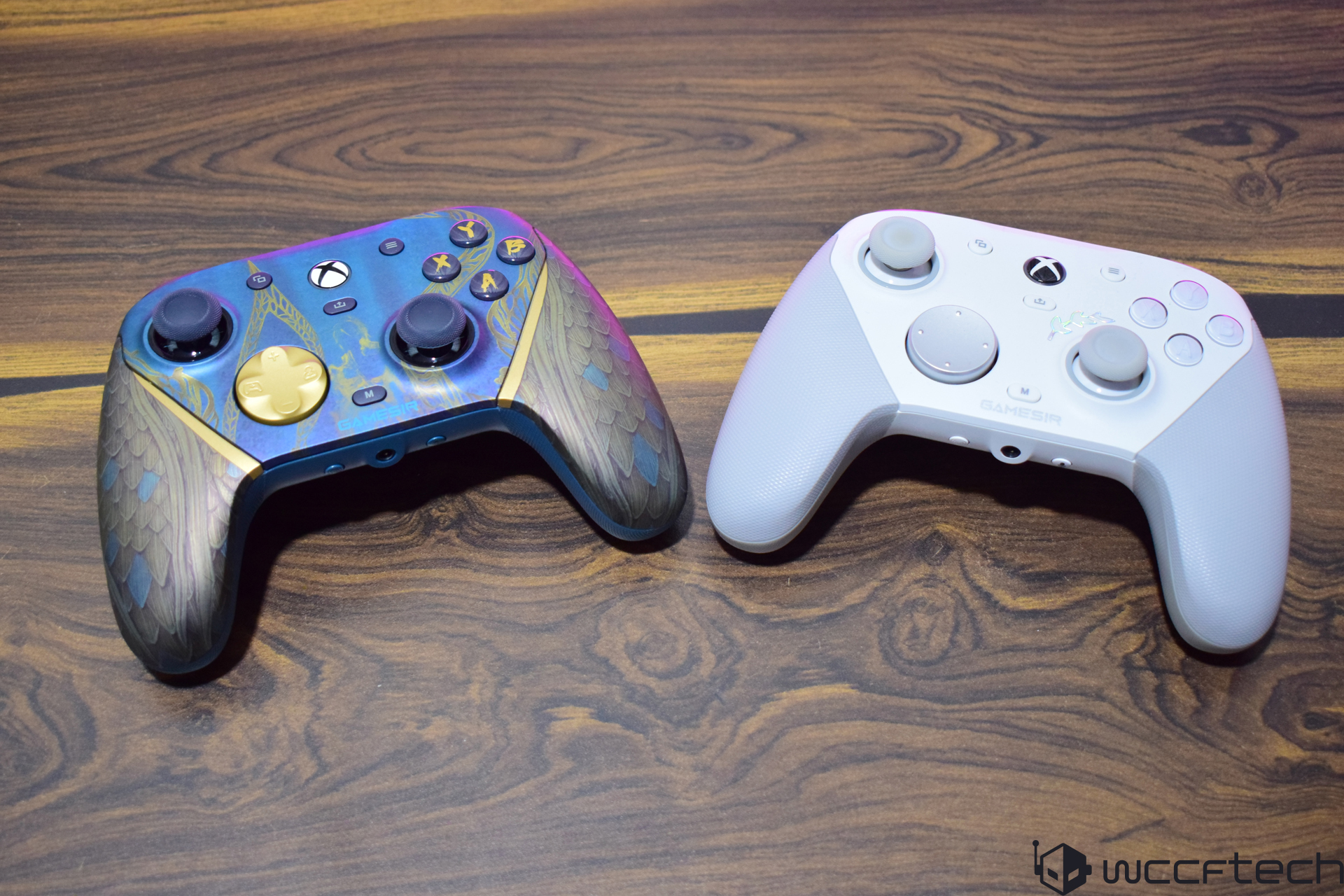 Two GameSir wireless controllers on a wooden table.